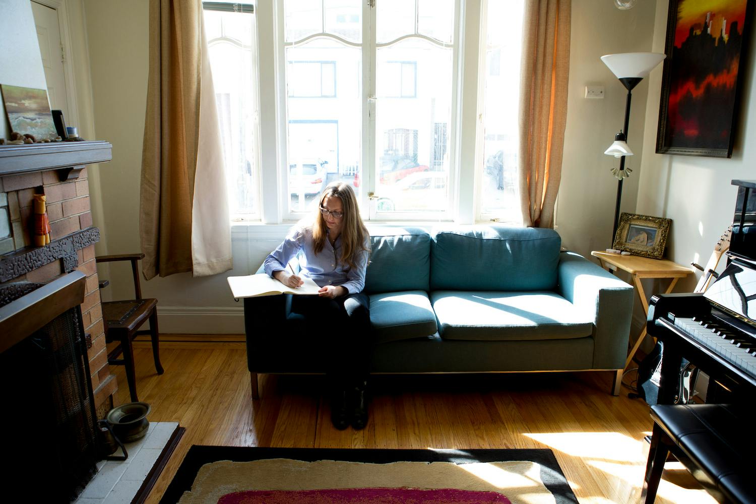 Julie Barwick composing on a couch